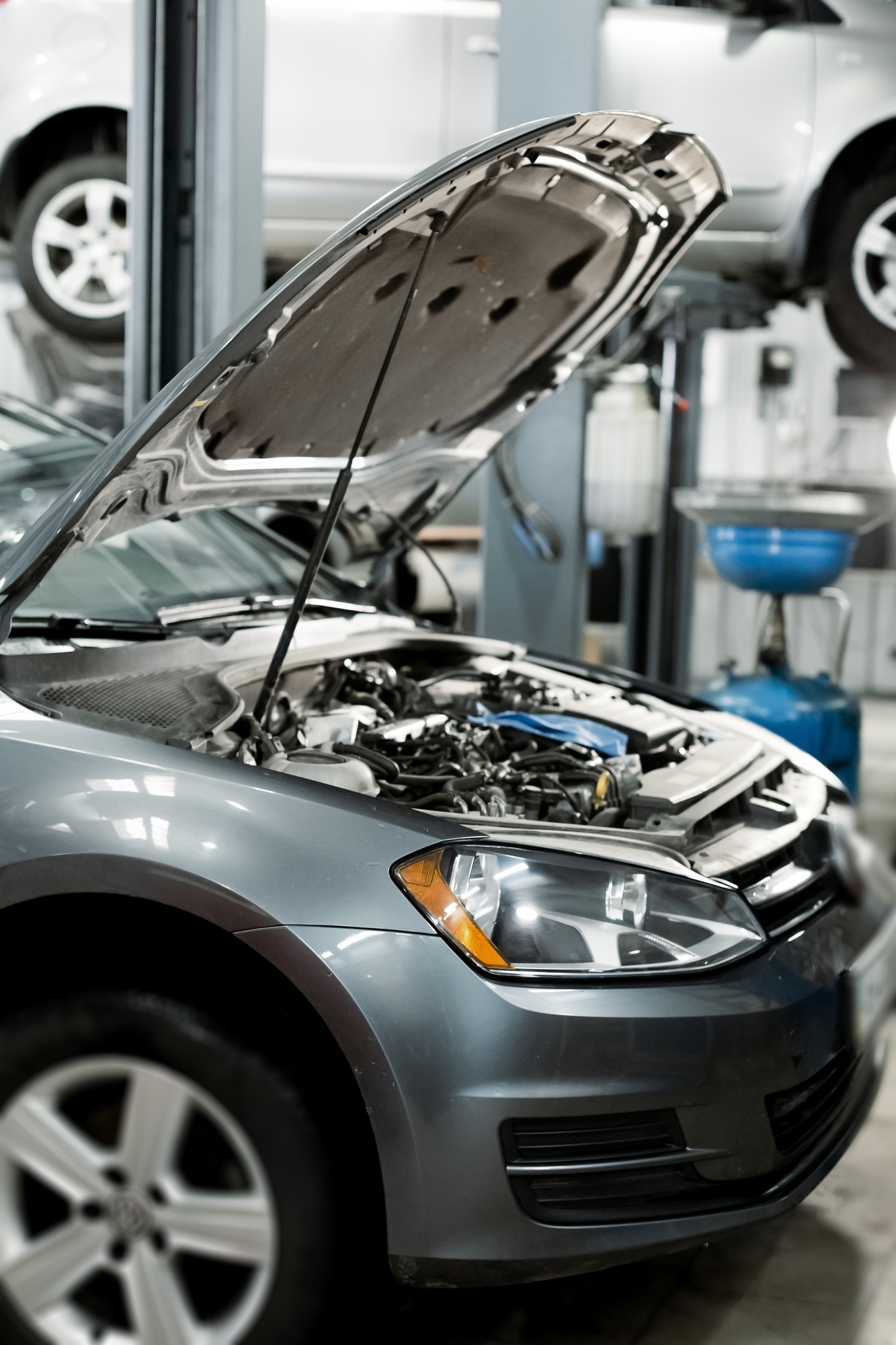 Service mechanic pouring new synthetic or organic oil lubricant into the engine